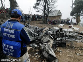 A U.N. worker at the site of the March helicopter crash that killed 10 people in Nepal.