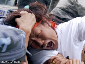 A protester is grabbed by Nepalese police during a demonstration in Kathmandu.