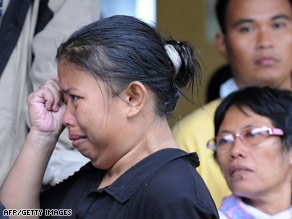 Relatives wait in Manila port Sunday for news; few survivors have been rescued, officials said.