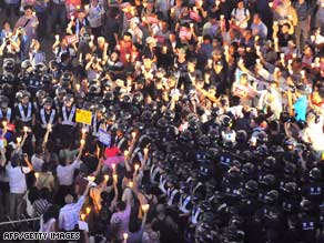 South Korean police surround protesters against U.S. beef imports in Seoul Sunday.