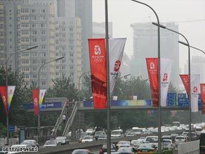 A sign pointing to special Olympic vehicle lanes stands out in the smog on Sunday in Beijing.