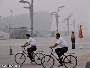 Beijing police line up with an Olympic Fuwa mascot at the National Stadium.