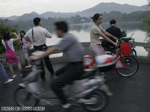 Ying Ying Joyce Choi, right on red bike, is both citizen and foreigner as she rediscovers China.