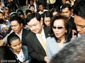 Pojaman Shinawatra and her husband Thaksin leave Bangkok Criminal Court on July 31 in Bangkok.