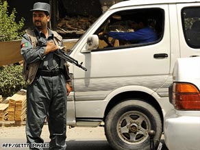 An Afghan policeman stops a vehicle at a checkpoint in  Kabul, where security has been tightened.