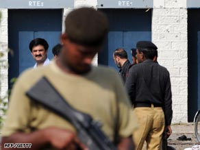 Police and authorities investigate the scene of the arms factory blast in Wah, near Rawalpindi.