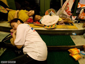 Protesters with the People's Alliance for Democracy sleep outside the goverment complex Friday in Bangkok.