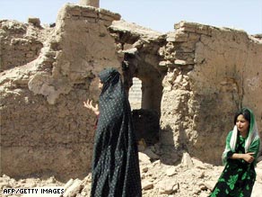 Civilians are overcome with emotion outside a home destroyed by a U.S. airstrike in Afghanistan.