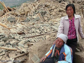 Farmers grieve in front of their destroyed property in the aftermath of the May 2008 earthquake.