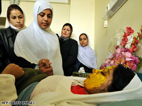 Schoolgirls visit a 17-year-old victim of this month's acid attack at a hospital in Kabul, Afghanistan.