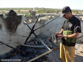 A police commando on Sunday inspects a checkpoint in Pakistan's Bannu district after militants attacked it.