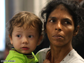 Sandra Samuel holds Moshe Holtzberg at the Mumbai airport in India on their way to Israel on December 1.