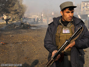 An Afghan policeman guards the scene of a suicide attack in Kabul on November 27.