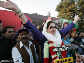 Benazir Bhutto greets supporters at the rally where she was later killed on December 27, 2007.