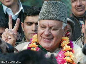 A National Conference party member flashes a victory sign Sunday in Srinagar.