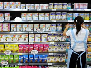 A salesgirl arranges powdered milk in China's Sichuan province in September.