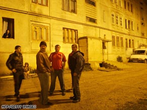 South Ossetians stand in the street during a night of shelling in Tskhinvali.