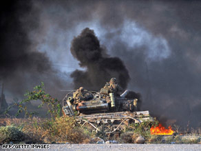 Georgian soldiers on a tank watch a Russian attack on a convoy outside Gori on Monday.