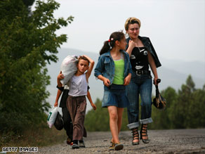 A Georgian family walks Tuesday from the bombed city of Gori on the road toward the capital, Tbilisi.