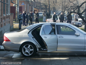 Russian police stand near the car of assassinated Vladikavkaz Mayor Vitaly Karayev.