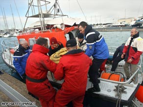 French rescue workers load an underwater search robot onto a boat.