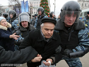Police detain a demonstrator at a political opposition rally in Moscow.