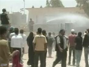 Palestinians watch as Egyptian forces fire a water cannon Wednesday at the Rafah border crossing.