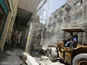 Workers clear debris during reconstruction along al-Mutanabi Street in central Baghdad, Iraq, in May.