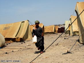 A Somali refugee walks past the United Nations-donated tents at a refugee camp west of Aden.
