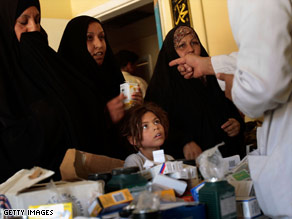 An Iraqi doctor hands out medications at a neighborhood clinic in Baghdad.