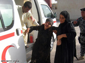 An Iraqi woman is helped into the Baquba hospital after she was injured in a roadside bombing Thursday.