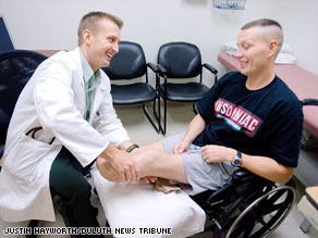 Retired Army Sgt. Brian Saaristo, who lost both legs to a roadside bomb, meets with a doctor in Minnesota.