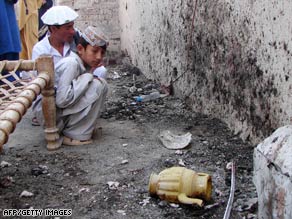 Pakistani tribesmen gather at the site of a missile attack in the troubled North Waziristan region on October 23.