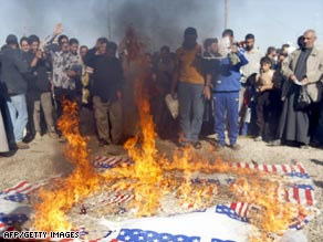 Shiite Muslims burn a replica of the American flag in the Sadr City district of Baghdad on Friday.