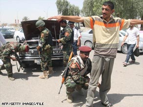 Iraqi Interior Ministry troops conduct inspections at a checkpoint in the southern Iraqi city of Basra in May.