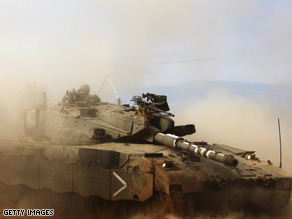 An Israeli tank maneuvers near the Israeli border with Gaza on Sunday near kibbutz Kisufim, Israel.