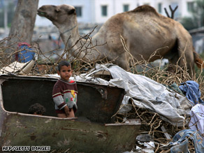 Impoverished Palestinian children play amid rubbish in a poverty-stricken southern Gaza City neighborhood.