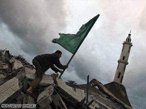 A Palestinian man surveys a Hamas government compound after an Israeli airstrike Tuesday.