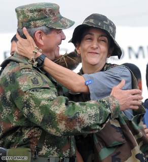 French-Colombian former politician Ingrid Betancourt (R) is hugged by Colombia's Army Gen.Mario Montoya