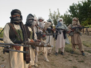 Taliban militants hold their weapons