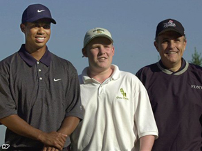 Andrew Giuliani, center, and his father Rudolph Giuliani, right, pose with Tiger Woods in 2001