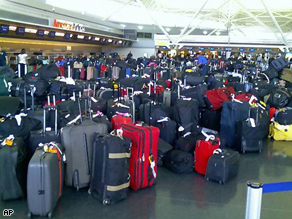 Hundreds of bags wait to be checked at New York's Kennedy Airport Wednesday. The  baggage system was not functioning, delaying some flights and others to take off without baggage.