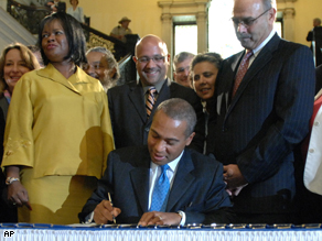 Govt. Deval Patrick signs a bill at the Statehouse in Boston, July, 31, repealing the 1913 law that blocked out-of-state gay couples from marrying in Massachusetts