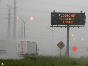A highway sign warns motorists as rains from tropical storm Edouard move across the state along Interstate 10 in Houston.