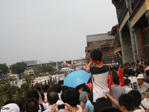 Crowds struggle to catch a glimpse of the torch.