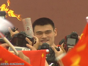 Another face in the crowd: Yao Ming carries the Olympic torch in Beijing.