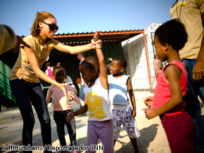 Yolaine Calixte, 16, plays with children outside of ‘granny-led’ home in Diepsloot