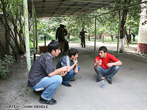 Ramaz Kuchiev, far right, a former soldier in the Russian army and other men wait for their papers to be processed so they can join the Russian army to join the fighting in South Ossetia and Georgia