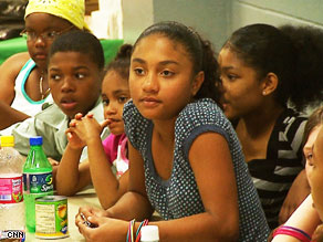  Queen Clyde, 12, proposing the idea of a bake sale to her Journey for Change friends.