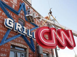 The sign at the CNN Grill in Denver is lowered into place ahead of the Democrat Convention.